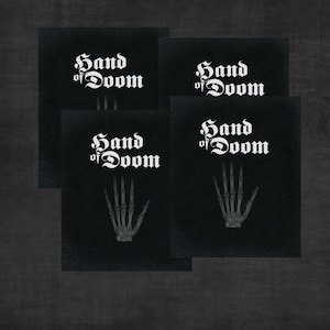 May include: Four black fabric patches with white text and a skeletal hand image. The text reads "Hand of Doom".