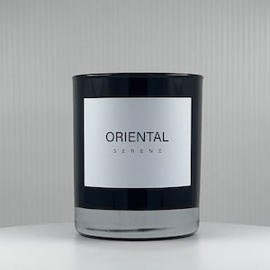 May include: Black glass candle jar with a white label that reads "Oriental Serene".