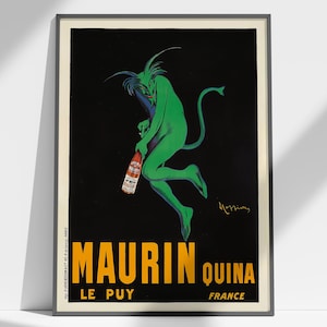 May include: Vintage poster featuring a green devil-like figure holding a bottle against a black background. The poster has the words "MAURIN QUINA" in yellow, with "LE PUY FRANCE" below. The poster is framed.