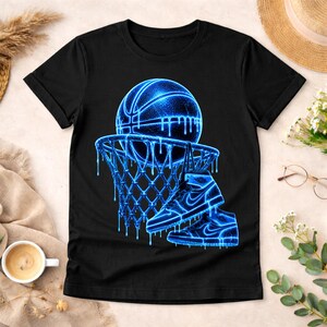 May include: A black short-sleeve t-shirt featuring a graphic print of a basketball, a basketball hoop, and a high-top sneaker. The design is rendered in a glowing neon blue color with a dripping liquid effect throughout the entire illustration.