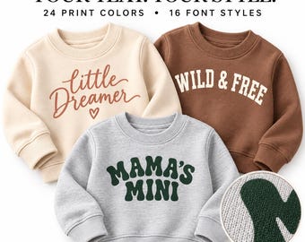 Può includere: Tre felpe a maniche lunghe con girocollo in color crema, marrone e grigio mélange. La felpa color crema presenta la scritta 'little DREAMER' con un cuore. La felpa marrone riporta 'WILD & FREE'. La felpa grigia riporta 'MAMA'S MINI'.