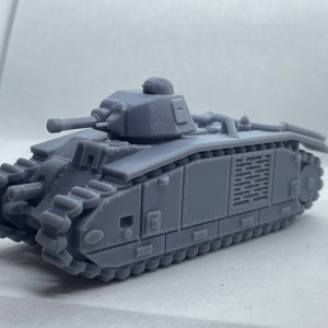 May include: A gray model tank with a detailed design, featuring a turret, cannon, and tread tracks. The miniature tank is a replica of a military vehicle, showcasing its structure and components. The model is made of a solid material.
