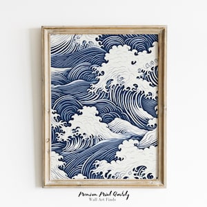 May include: A framed art print showing a stylized depiction of ocean waves in blue and white. The artwork is in a light brown wooden frame. The print has a vintage aesthetic and is suitable for wall decor. The print is in a wooden frame.