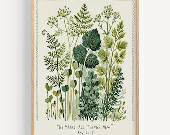 Op de afbeelding: Botanische aquarelprint met verschillende tinten groen blad. Het kunstwerk is ingelijst in een licht houten frame met een geschulpte rand. De tekst "HE MAKES ALL THINGS NEW" en Rev 21:5 staat onderaan afgedrukt.