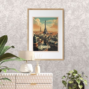 May include: A framed poster with a vintage illustration of the Eiffel Tower in Paris, France. The poster has a light blue sky with white clouds and a yellow sunset in the background. The text "PARIS" is printed in white at the bottom of the poster.
