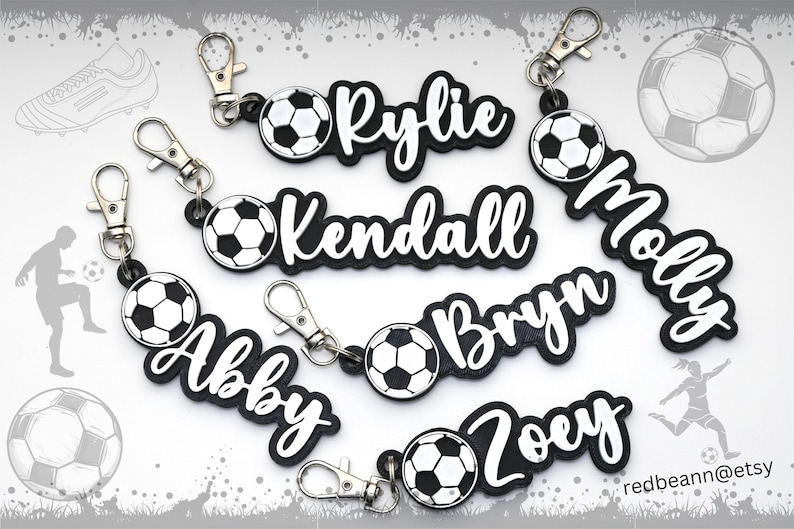 May include: Seven black and white personalized soccer ball keychains with names "Rylie", "Kendall", "Molly", "Brynn", "Abby", "Zoey" and a soccer ball.