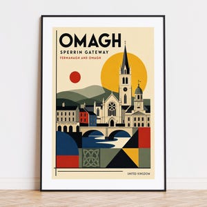 May include: A framed travel poster featuring a stylized illustration of Omagh, Sperrin Gateway, Fermanagh and Omagh, United Kingdom. The artwork depicts a church, a bridge, and buildings in a flat graphic style with a yellow sun and red circle.