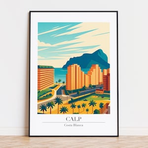May include: A framed art print featuring a stylized illustration of Calp, Costa Blanca. The artwork depicts orange buildings, palm trees, a road, and a mountain against a blue sky and sea. The word "CALP" is printed below the image.