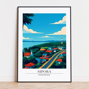 May include: A framed art print showing a stylized illustration of Sipora, Indonesia. The artwork depicts a coastal village with red-roofed houses, a winding road, and a church, set against a blue sky with fluffy clouds. The text "SIPORA INDONESIA" is at the bottom.