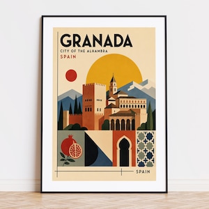 May include: A framed travel poster featuring Granada, Spain, with the text "Granada City of the Alhambra Spain." The artwork depicts the Alhambra palace, a sun, mountains, and a pomegranate.