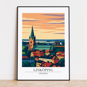 May include: A framed art print featuring a stylized illustration of Linköping, Sweden. The artwork depicts a cityscape with a prominent church and colorful buildings under an orange and blue sky. The text "LINKÖPING SWEDEN" is at the bottom.