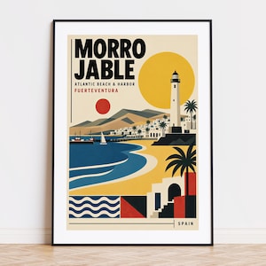 May include: A framed travel poster featuring the text MORRO JABLE ATLANTIC BEACH & HARBOR FUERTEVENTURA SPAIN. The illustration depicts a lighthouse, a yellow sun, mountains, a blue ocean, a sandy beach, palm trees, and geometric patterns.