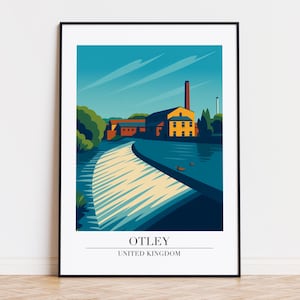 Puede incluir: Una impresión artística enmarcada que presenta una ilustración estilizada de Otley, Reino Unido. La obra de arte representa un edificio amarillo con una chimenea roja, un río y un cielo azul. El texto "OTLEY UNITED KINGDOM" está en la parte inferior.