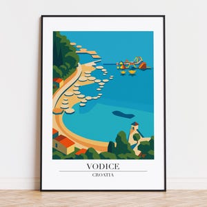 May include: A framed art print featuring a coastal scene in a minimalist style. The artwork depicts a bay with a beach, buildings, and boats, rendered in shades of blue, green, orange, and yellow. The text "VODICE CROATIA" is at the bottom.