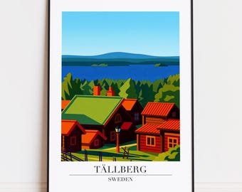 Op de afbeelding: Een ingelijste kunstprint met een gestileerd landschap van Tällberg, Zweden. Het kunstwerk toont roodbedekte gebouwen met groene daken tussen bomen, met uitzicht op een blauw meer en lucht. De tekst "TÄLLBERG SWEDEN" staat onderaan.