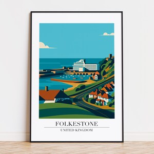 May include: A framed print of Folkestone, UK, in a minimalist style. The artwork shows a coastal town with a harbour, buildings, and a road winding through green hills. The sky is blue with clouds. The text "FOLKESTONE UNITED KINGDOM" is at the bottom.