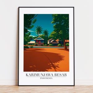 May include: A framed art print featuring a stylized landscape of Karimunjawa Besar, Indonesia. The artwork depicts colorful houses, palm trees, and a road under a blue sky. The text "KARIMUNJAWA BESAR INDONESIA" is at the bottom.