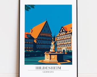 Könnte beinhalten: Ein gerahmter Kunstdruck mit einer stilisierten Illustration von Hildesheim, Deutschland. Das Kunstwerk zeigt Gebäude mit orangefarbenen Dächern, einen Brunnen und den Text "Hildesheim Germany" am unteren Rand. Der Hintergrund ist leuchtend blau.