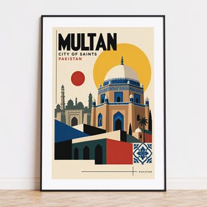 May include: A framed travel poster featuring the text MULTAN CITY OF SAINTS PAKISTAN. The illustration depicts a tan domed mausoleum with blue tile accents, a red sun, and geometric architectural shapes in blue, red, and black.