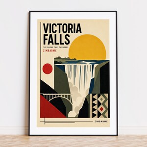 May include: A framed art print featuring a stylized depiction of Victoria Falls in Zimbabwe. The artwork includes a large yellow sun, the falls, a bridge, and geometric patterns in red, black, and beige. Text reads "Victoria Falls" and "The Smoke That Thunders".