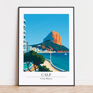 May include: A framed art print featuring a stylized landscape of Calp, Spain. The image showcases a mountain with an orange peak, a blue sea, and a coastal town. The word "CALP" and "Costa Blanca" are printed at the bottom.