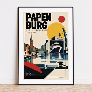 May include: A framed travel poster of Papenburg, Germany, featuring a stylized illustration of a cruise ship in a shipyard, a bridge, and a church tower. The design includes a large yellow sun, a red circle, and text reading Papenburg.