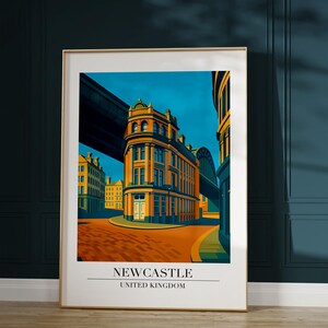 May include: A framed art print featuring a stylized illustration of a street scene in Newcastle, United Kingdom. The artwork showcases a building with orange and yellow tones under a blue sky. The print includes the text "NEWCASTLE UNITED KINGDOM".