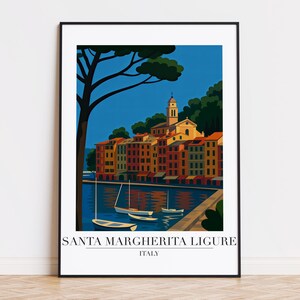 May include: A framed art print of Santa Margherita Ligure, Italy, showing a coastal scene with colourful buildings, boats, and a tree against a blue sky. The text at the bottom reads "SANTA MARGHERITA LIGURE ITALY."
