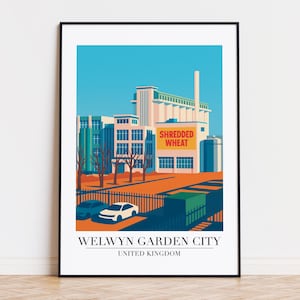 Op de afbeelding: Een ingelijste print met een gestileerde illustratie van de Shredded Wheat-fabriek in Welwyn Garden City, Verenigd Koninkrijk. Het kunstwerk gebruikt een beperkt kleurenpalet van blauw, oranje en wit, met de tekst "Shredded Wheat" prominent aanwezig.
