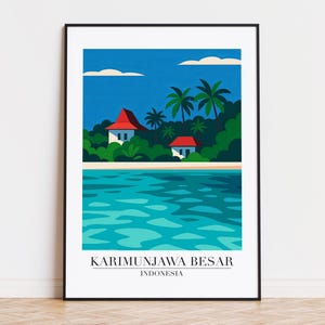 May include: A framed art print featuring a stylized tropical landscape. The artwork depicts a blue ocean, a sandy beach, and lush green foliage with two white houses and red roofs under a blue sky. The text "KARIMUNJAWA BESAR INDONESIA" is at the bottom.