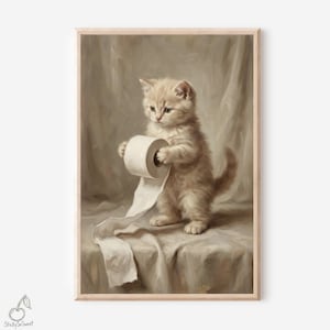 May include: A framed print depicting a kitten with a light brown coat, playing with a roll of toilet paper. The kitten stands on a draped surface, with a neutral-toned background. The artwork has a vintage aesthetic.