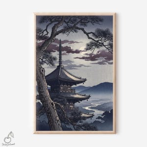 May include: A framed print of a Japanese pagoda in a landscape. The artwork features a multi-tiered pagoda, a river, and mountains in shades of blue and gray, with a tree in the foreground. The sky has a full moon and clouds.