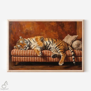 May include: A framed print depicting a tiger relaxing on a striped sofa. The tiger's fur is orange and black. The sofa has red and white stripes. A beige pillow and a round cushion are behind the tiger. The background is dark orange.