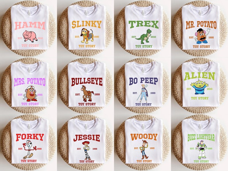 May include: Twelve white t-shirts with different Toy Story characters printed on them. Each shirt has the character's name, "Toy Story", and "EST." followed by a year.