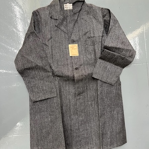 May include: A gray, long-sleeved coat with a notched collar and two front pockets. The coat has a button closure and a small tag attached. The fabric has a subtle vertical stripe pattern.