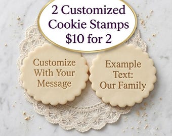 May include: Two round, scalloped-edge cookie stamps with embossed text. One stamp features the text 'Customize With Your Message' and the other features 'Example Text: Our Family'. The stamps are light beige and have a circular design.
