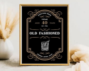 May include: A framed black and gold print with the text "Old Fashioned" and a graphic of the cocktail. The print is labeled "Vintage Aged 40 Years Est. 1984" and includes the ingredients Bourbon, Bitters, and Sugar.