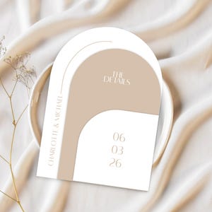 May include: A wedding invitation card with a modern design. The card features a white arch shape with a beige overlay and the text "THE DETAILS". The names "CHARLOTTE & MICHAEL" and the date "06 03 26" are also displayed.
