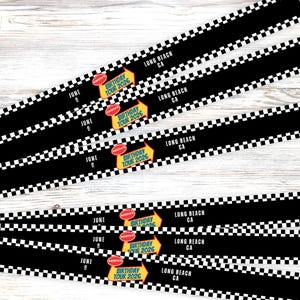 May include: Black and white checkered strips with the text "Long Beach CA" and "Birthday Tour 2026". The date "June 9" is also printed on the strips. The strips have a road-like design.