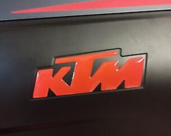 Pair of 3D resin stickers with KTM lettering.