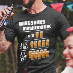 May include: A black t-shirt with white text that reads "Wirtshaus Mathematik" and a graphic of beer glasses. The text below the graphic reads "1 Bier", "1 bis 2 Bier", and "Ein Paar Bier".
