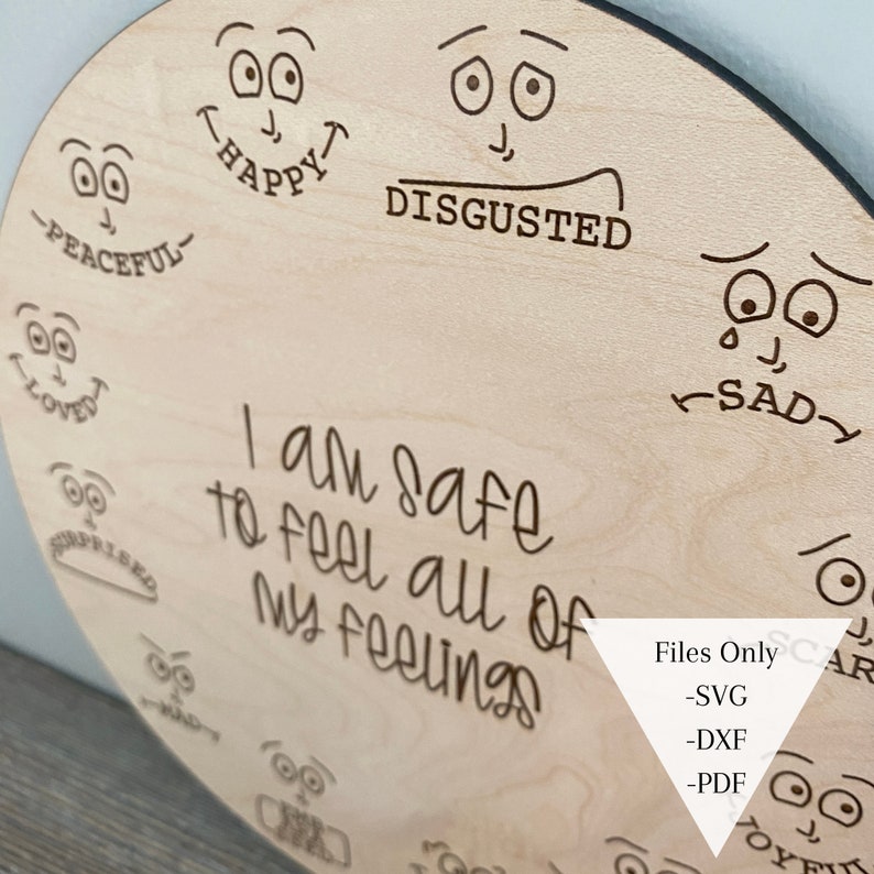 May include: A wooden circle with various emotions drawn on it. The text "I am safe to feel all of my feelings" is written in the center. The circle is labeled "Files Only -SVG -DXF -PDF".