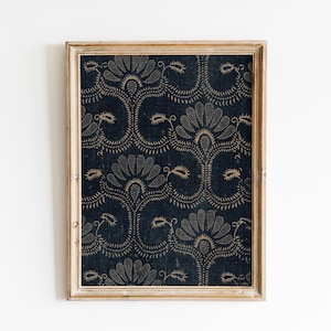 May include: A framed print with a dark blue background and a white floral pattern. The frame is a light wood color.