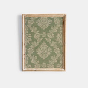 May include: A framed green and white floral patterned fabric with a white wood frame.