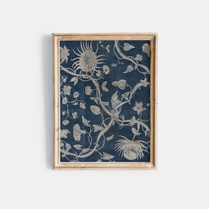 May include: A framed print of a vintage floral design on a blue background. The design features white flowers and vines.
