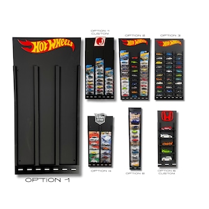 May include: Black wall-mounted display for Hot Wheels cars. The display has six different options, including a custom option. The display is made of black acrylic and has a black metal frame. The display is designed to hold Hot Wheels cars in a vertical position. The display is labelled with the text "OPTION 1" at the bottom.