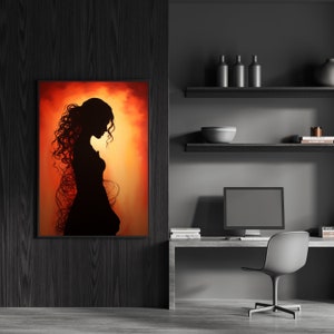 May include: A framed painting depicting a woman's silhouette in a long dress, standing against a sunset-coloured background.