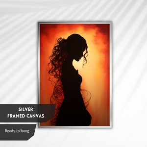 May include: A framed canvas print featuring a silhouette of a woman with long, flowing hair against a fiery orange and yellow background.