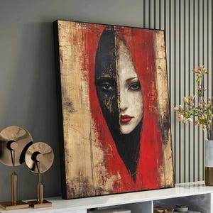 Puede incluir: Una pintura de la cara de una mujer con la mitad de su cara pintada de negro y la otra mitad de blanco. Lleva una bufanda roja y tiene una expresión seria.