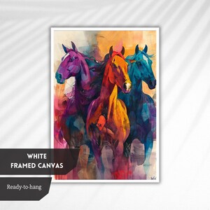 May include: Abstract painting of three horses running, painted in shades of purple, orange, and blue. The painting is framed in white.